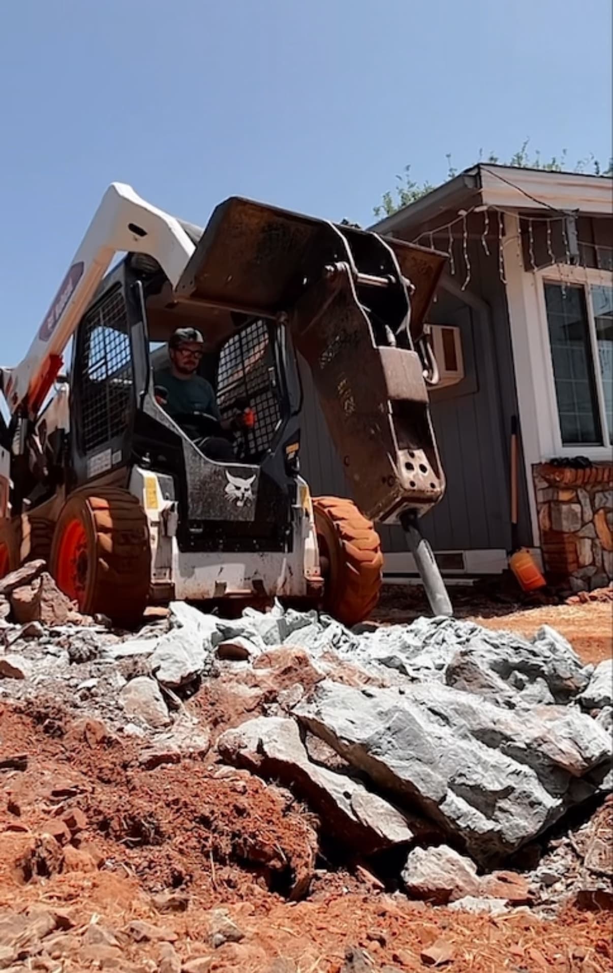 Skid steer working through rock during site preparation