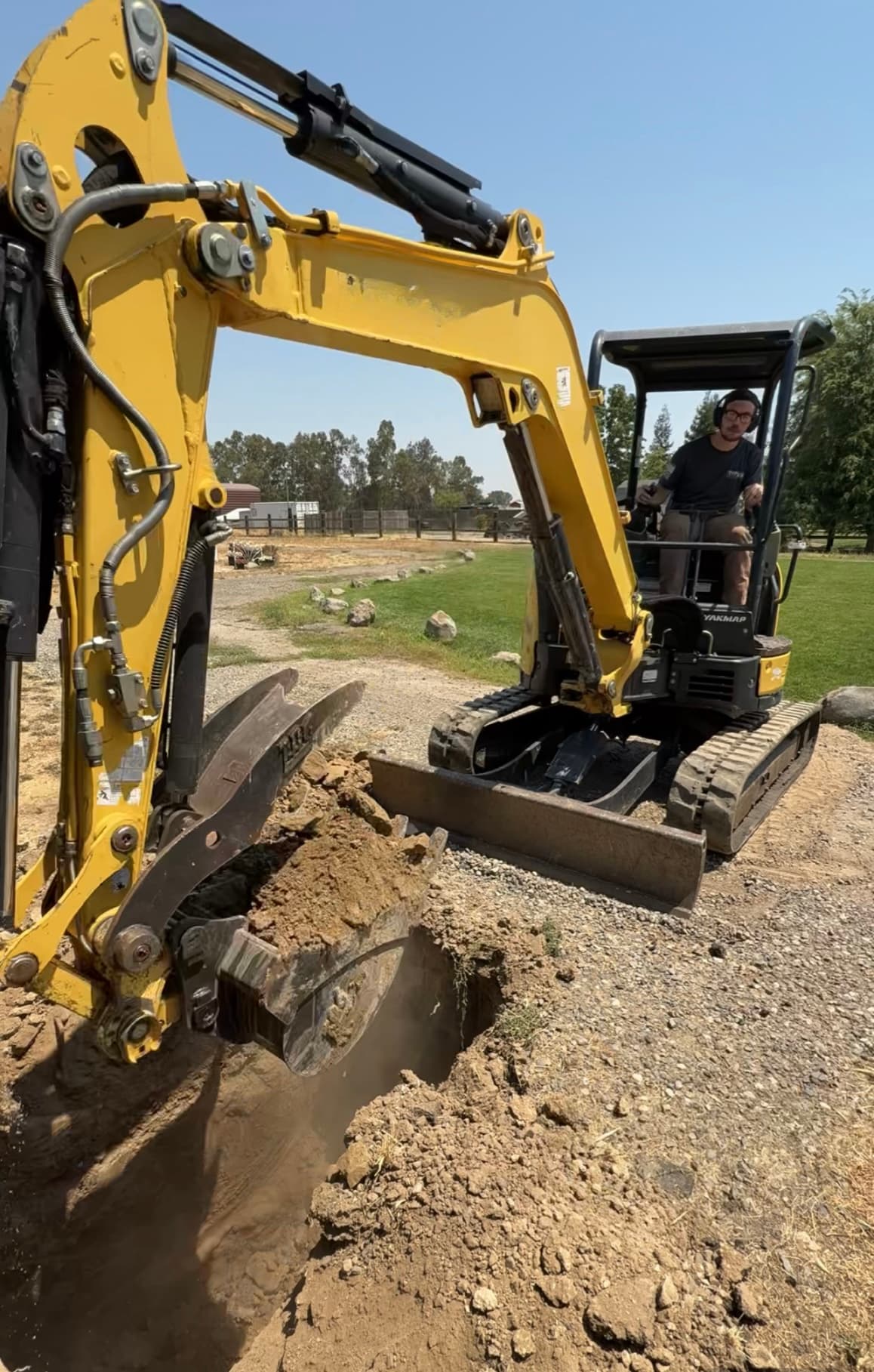 Compact excavator opening a controlled trench for below-grade work
